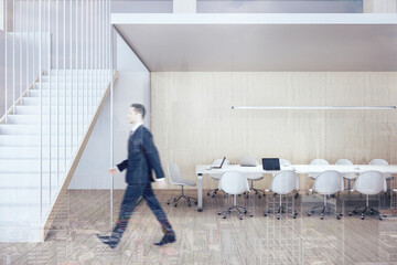 Fototapeta premium Businessman walking in modern conference interior