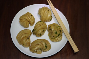 Steamed bread, typically made from wheat, prepared by steaming 