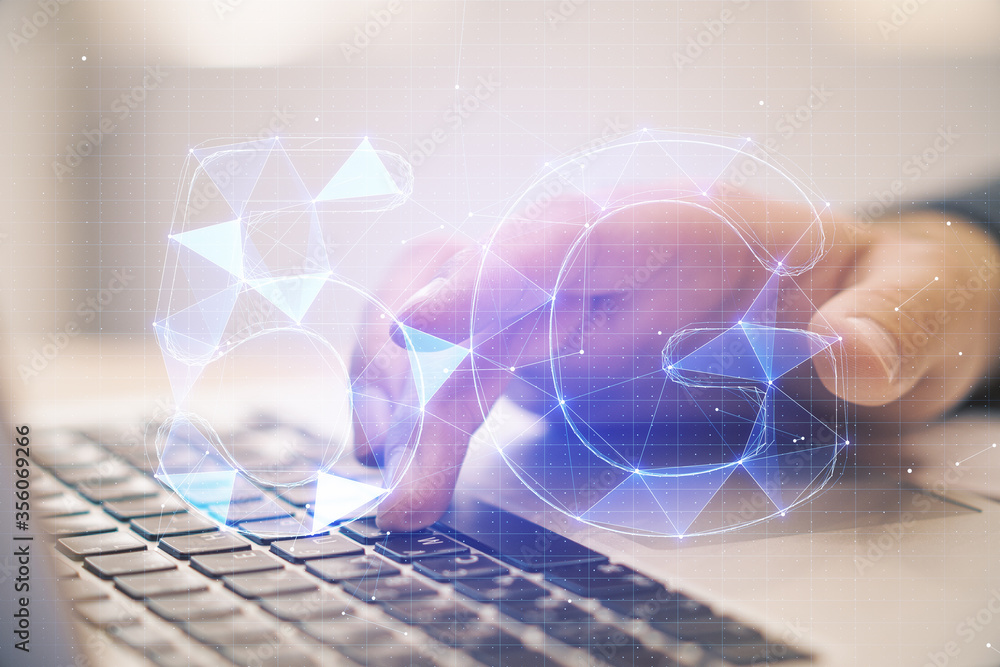 Poster Hands using laptop on desktop with abstract 5G network hologram.