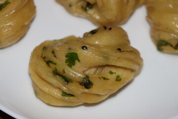 Steamed bread, typically made from wheat, prepared by steaming 