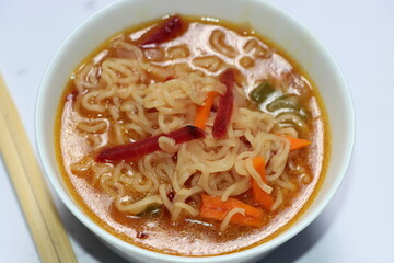 Noodle with vegetables in white bowl, Spicy noodle soup. Still life