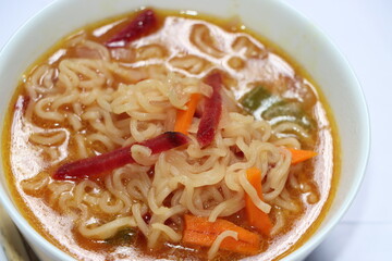 Noodle with vegetables in white bowl, Spicy noodle soup. Still life