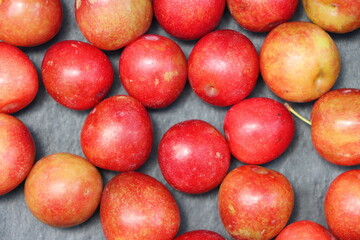 Fresh plum fruits on black background