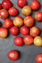 Fresh plum fruits on black background