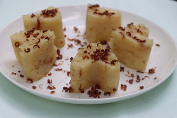 Suji Halwa or sheera, Indian sweet dish. Semolina dessert served in preety heart shape cake