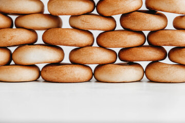 Drying or mini round bagels on a white wooden background. Copy, empty space for text