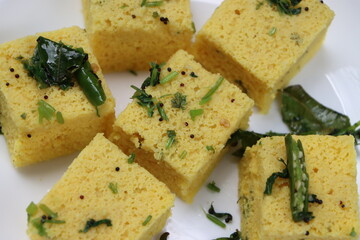Dhokla, breakfast or snack mainly in Indian states Gujarat and maharashtra, made with a fermented batter derived from rice and split chickpeas