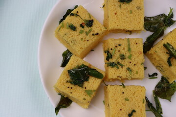 Dhokla, breakfast or snack mainly in Indian states Gujarat and maharashtra, made with a fermented batter derived from rice and split chickpeas