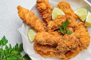Crispy fried chicken in a white bowl.