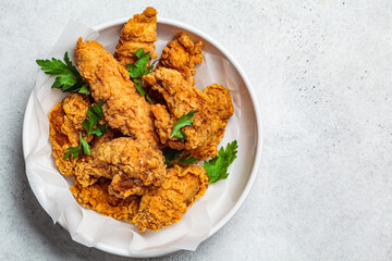 Crispy fried chicken in a white bowl.