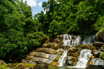Fototapeta na wymiar Waterfall Splash down on the rock at Ton Tok Waterfall, Palian District, Trang, Thailand.