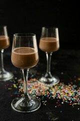 selective focus: chocolate and coffee liqueur in a tall stack on a dark table