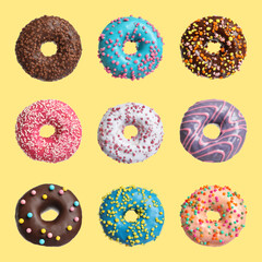 Fototapeta na wymiar Set with delicious glazed donuts on yellow background