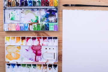 Top view of art supplies on the wooden table