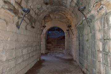Merida in Spain. Roman Amphitheatre. Stone tunnel with torches
