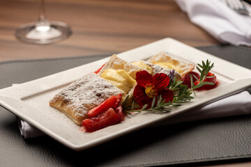 Puff Pastry with cream, strawberry and sugar on top