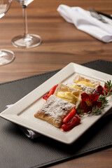 Puff Pastry with cream, strawberry and sugar on top
