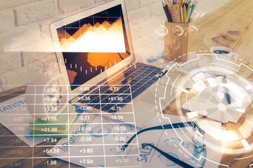 Financial graph colorful drawing and table with computer on background. Multi exposure. Concept of international markets.