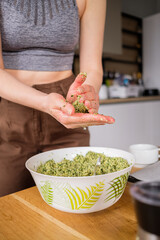Lovely woman with beautiful hands cooking falafel in a modern kitchen. Healthy food, fitness, and sport diet concept.