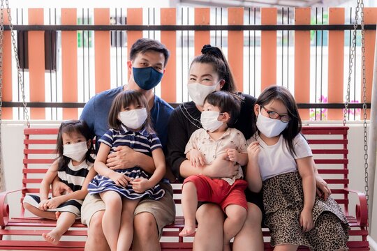 New Normal Family Life With Coronavirus Situation. Lifestyle At Home In Outbreak COVID-19. Wearing Quarantine Virus Protective Face Mask Is The  Key Heart To Prevention Which Starts In Family At Home.