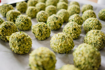 Raw falafel arranged on baking paper in the tray. Healthy food diet, vegan background