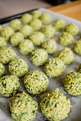 Raw falafel arranged on baking paper in the tray. Healthy food diet, vegan background