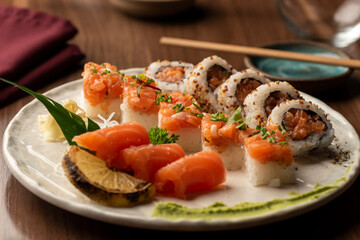 Japanese sushi sashimi salmon set on plate with napkin chopsticks on background