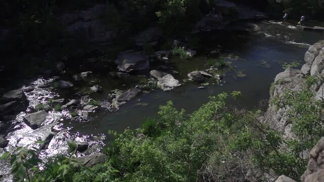 The river flows in a granite canyon. Slow motion