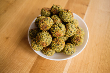 Close-up of delicious Falafel balls on white plate on wooden table, healthy life concept. Healthy food diet, vegan background