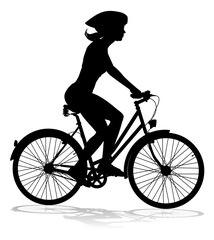 Bicyclist riding their bike and wearing a safety helmet in silhouette