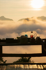 Silhouette of Thai ingredients and condiment on wooden terrace of noodle shop during a beautiful morning sky with waves of fog at Baan Ja Bo village viewpoint of Pang Mapha,Mae Hong Son,Thailand.