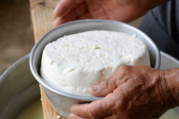 After following the cheese production process, the shepherd begins to shape the final product