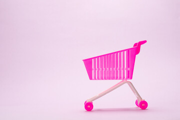 Blue present box with pink bow in a shopping cart
