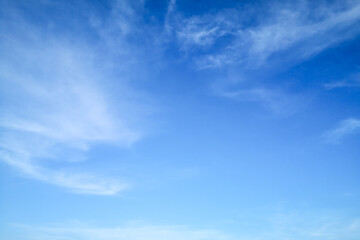 Blue sky with smooth clouds background.