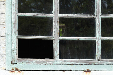 Old dirty wooden window frame without one glass.