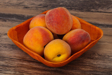 Peach heap in the wooden basket