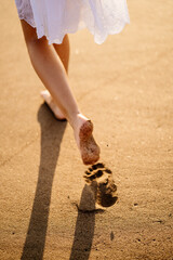 little feet leave footprints on sandy shore of sea. walks on beach. 