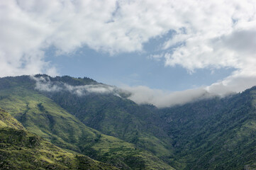 Altai mountains near the Katun river on a background of clouds. Green mountains and valley. Altai. Siberia.