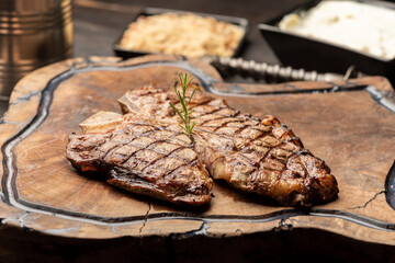 t-bone steak on a wooden board with a blurred background