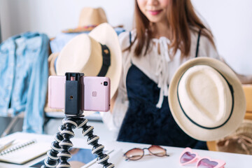 Asian woman entrepreneur talking camera live recording video on social network at home. Online...