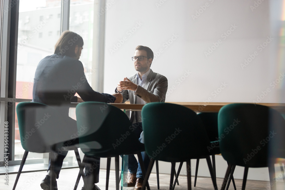 Wall mural negotiations process behind wall door concept, human resources manager interviewing candidate of com