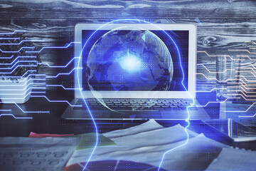 Double exposure of table with computer and brain hologram. Data innovation concept.