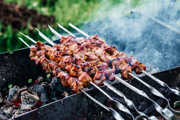 skewers on skewers cooked on the grill with smoke. outdoor grill at the cottage