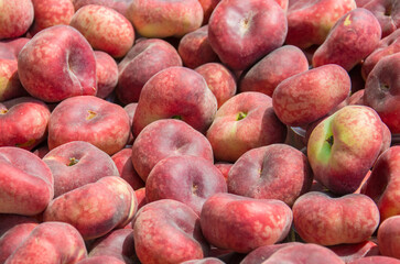 a group of red Saturn peaches 