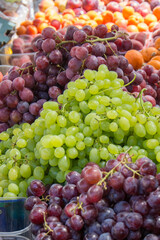  green and purple grapes in a market