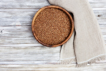 Appetizing buckwheats. Full plate with buckwheats on wooden background with copy space. Healthy eating. Rustic style.