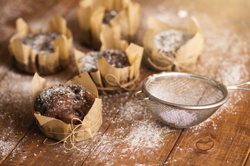Tasty chocolate muffins in powdered sugar