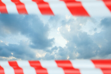 Obraz na płótnie Canvas Sky clouds closed warning tape, prohibition concept