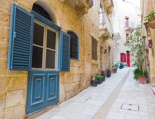 Typical old maltese street. Blue window, red door. Malta