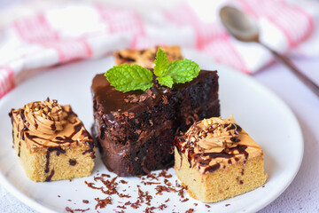 Coffee cake topping chocolate delicious sweet dessert served on the table - cake chocolate slice on white plate with mint leaf for breakfast